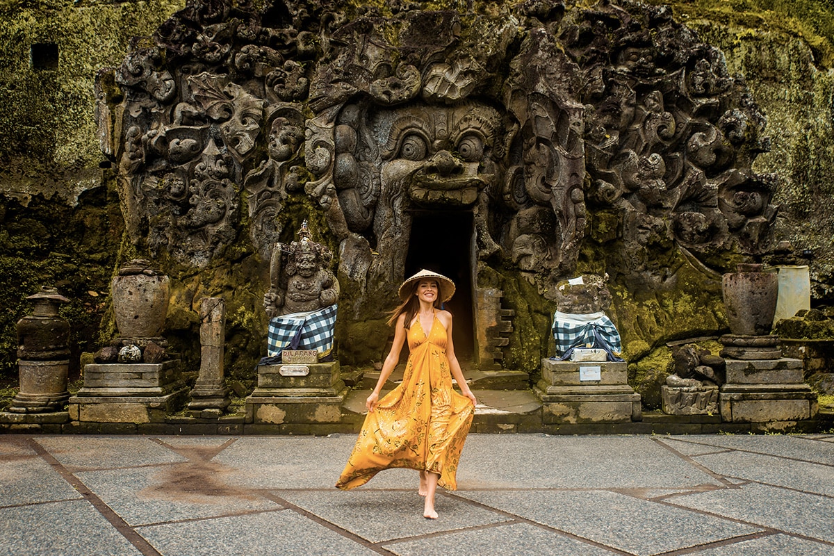a tourist with yellow dress at Goa Gajah Ubud Bali