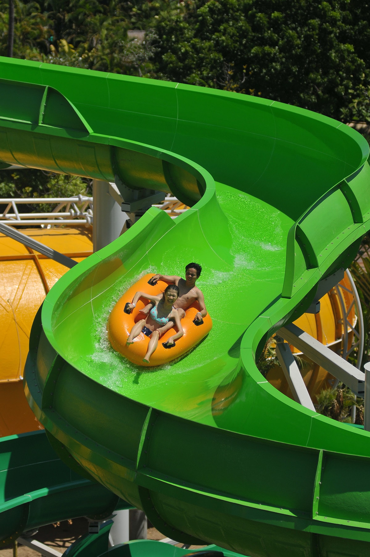 two kids sliding down a thrilling slide at Waterbom Bali