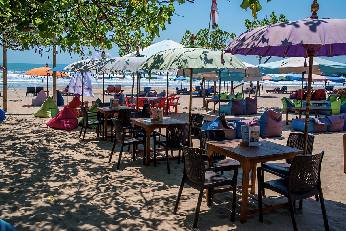 tables with beach umbrellas at Double Six Beach Seminyak Bali