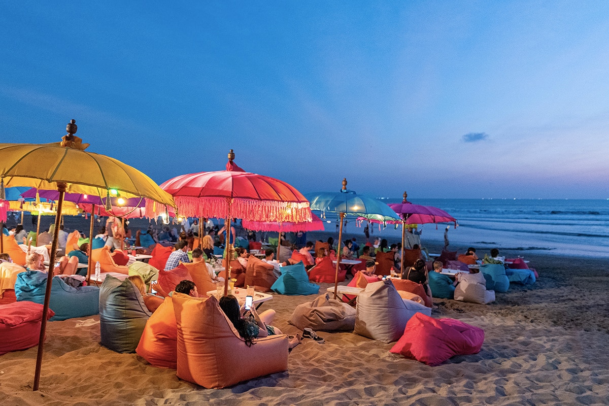people sitting at colorful bean bags at Seminyak Beach Bali