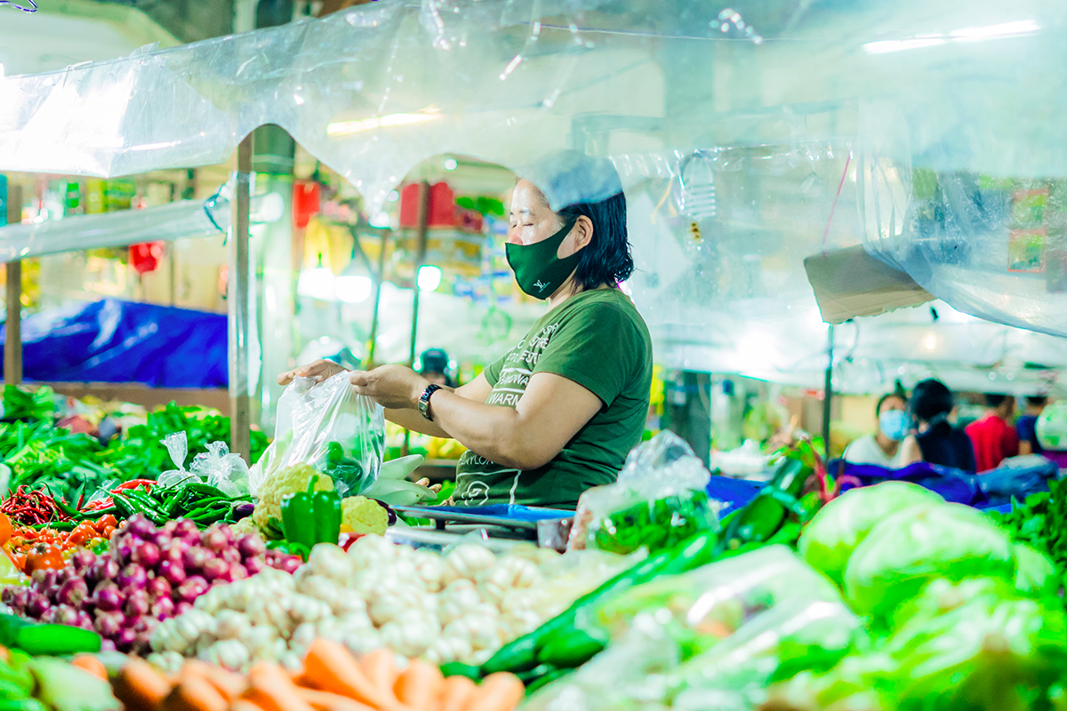 Indonesian woman selling fresh vegetables  in Badung Market, Denpasar