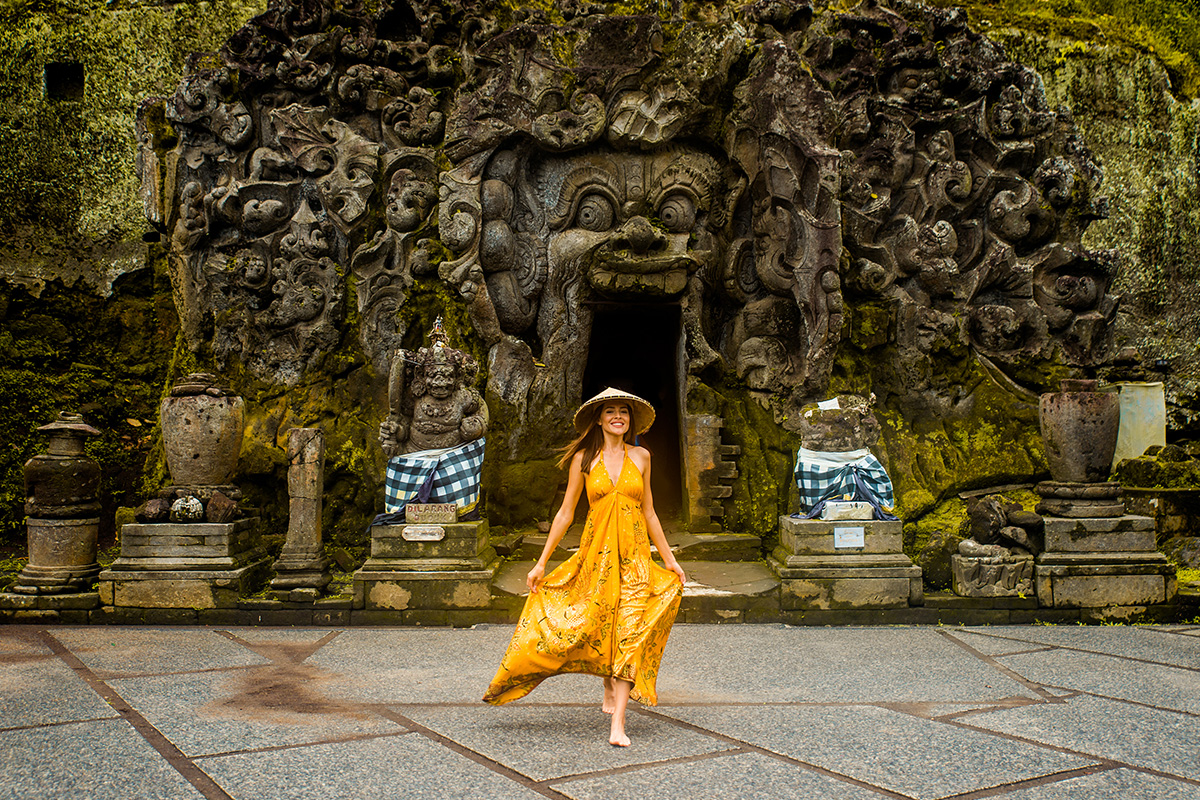 a tourist with yellow dress at Goa Gajah Ubud Bali