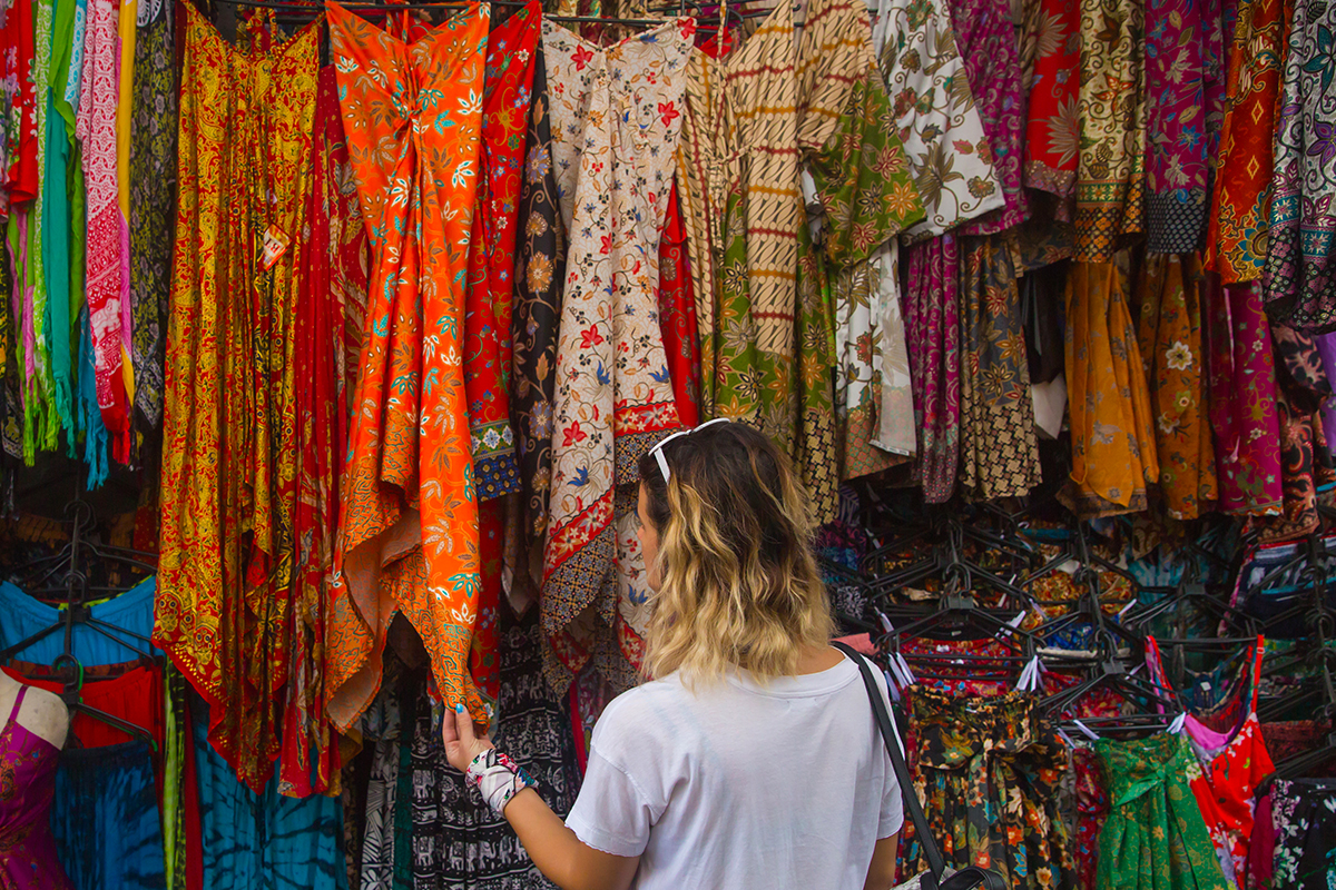 foreigner looking at vibrant art at Ubud Art Market Bali