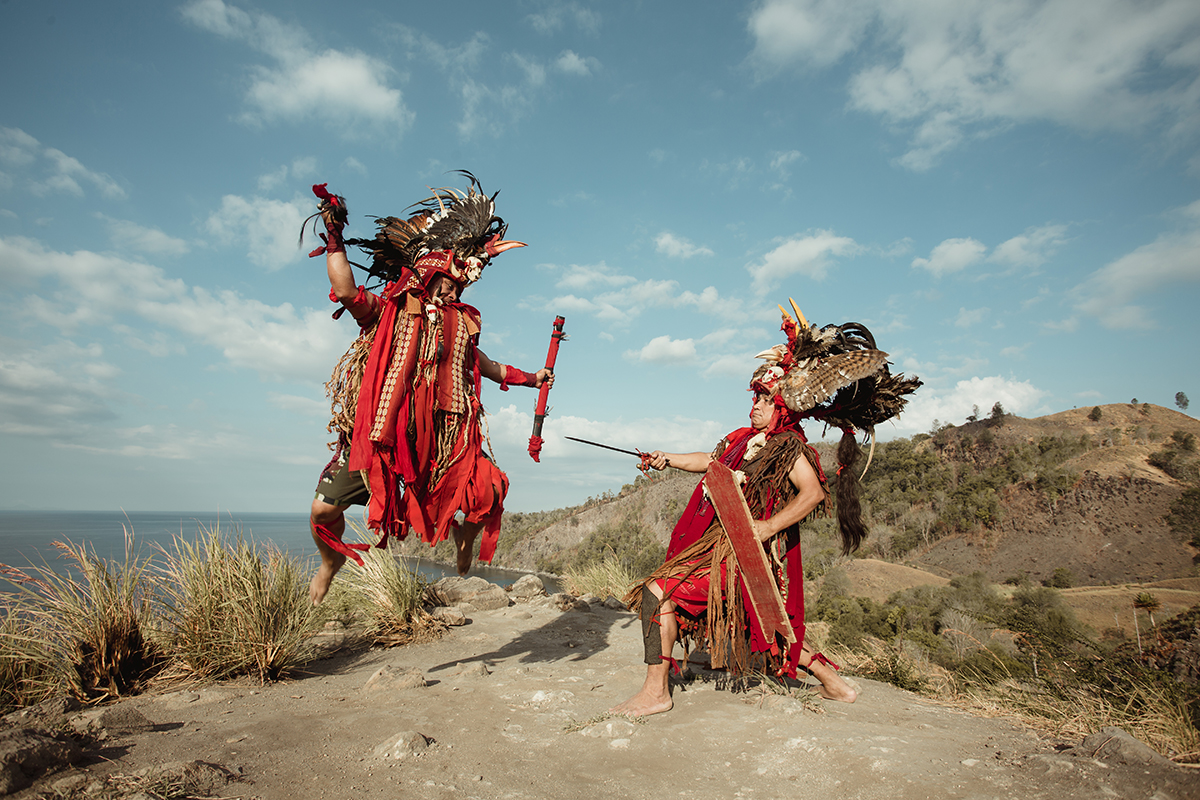 two people performing Kabasaran Dance in Likupang, North Sulawesi