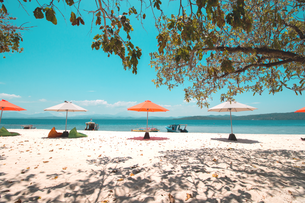 the blissful Lihaga Beach with orange and white parasols