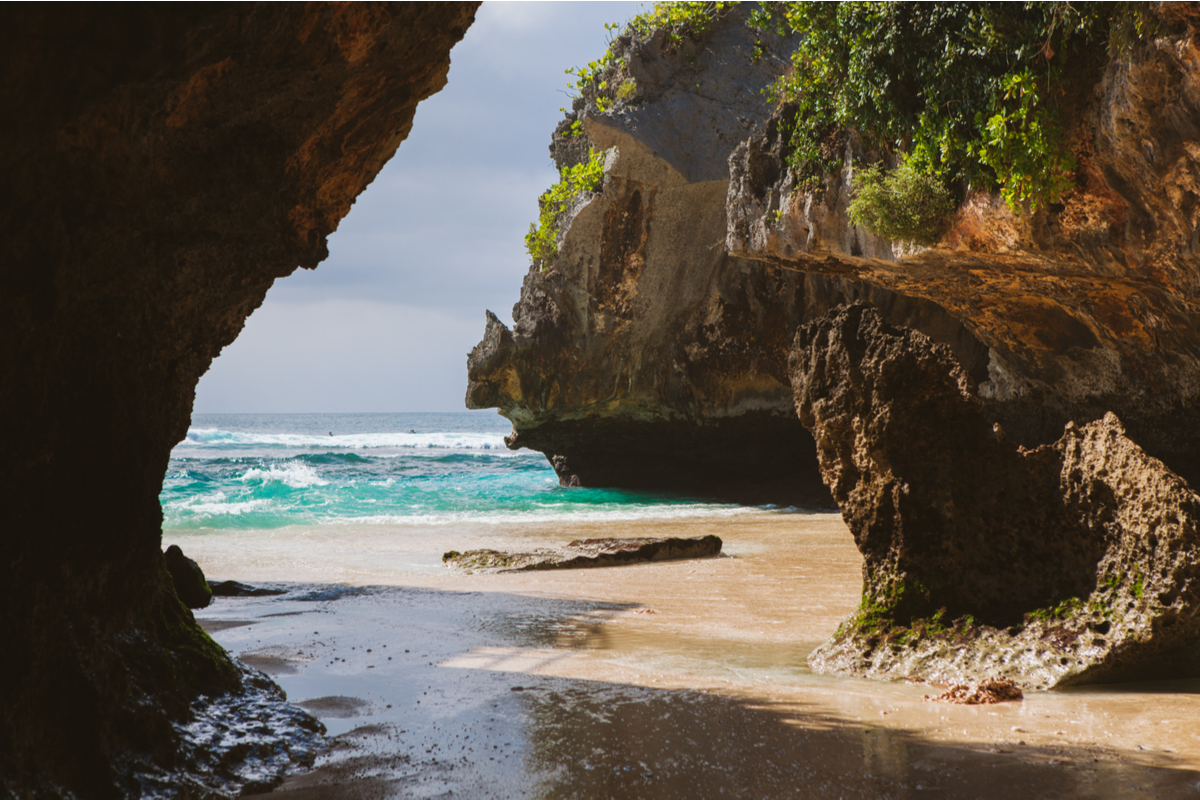 wet sand pristine waters and high cliffs at Suluban Beach Bali