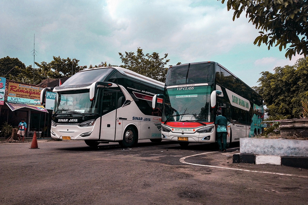 two buses parking in a station