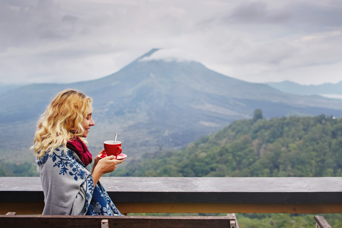 blond haired woman enjoying her coffee at Kintamani Bali