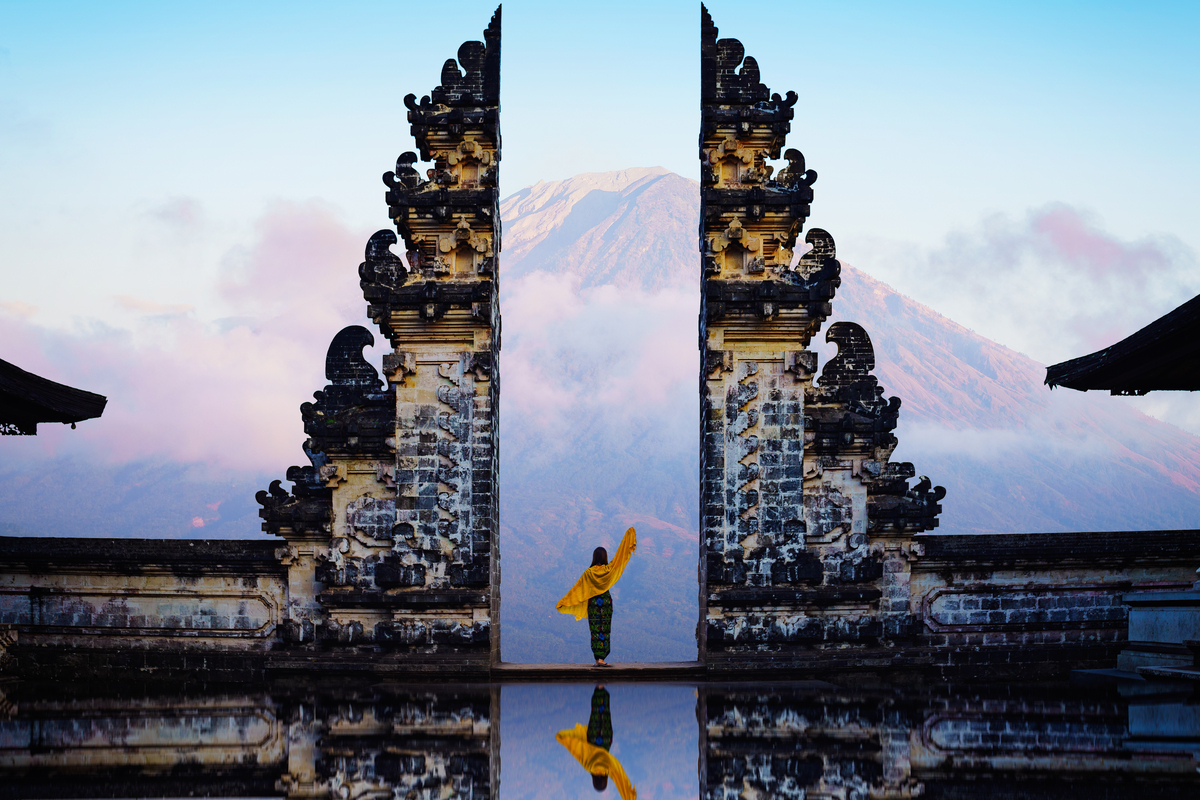 woman back posing with yellow scarf at Lempuyang Bali