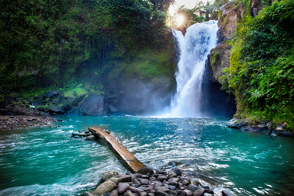 water plunging in the pool of water at Tegenungan Waterfall