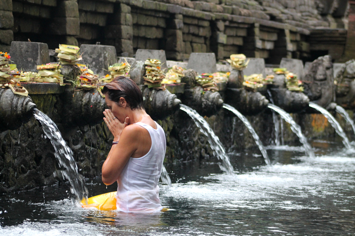 lady inside the holy purifying water at Tirta Empul Temple