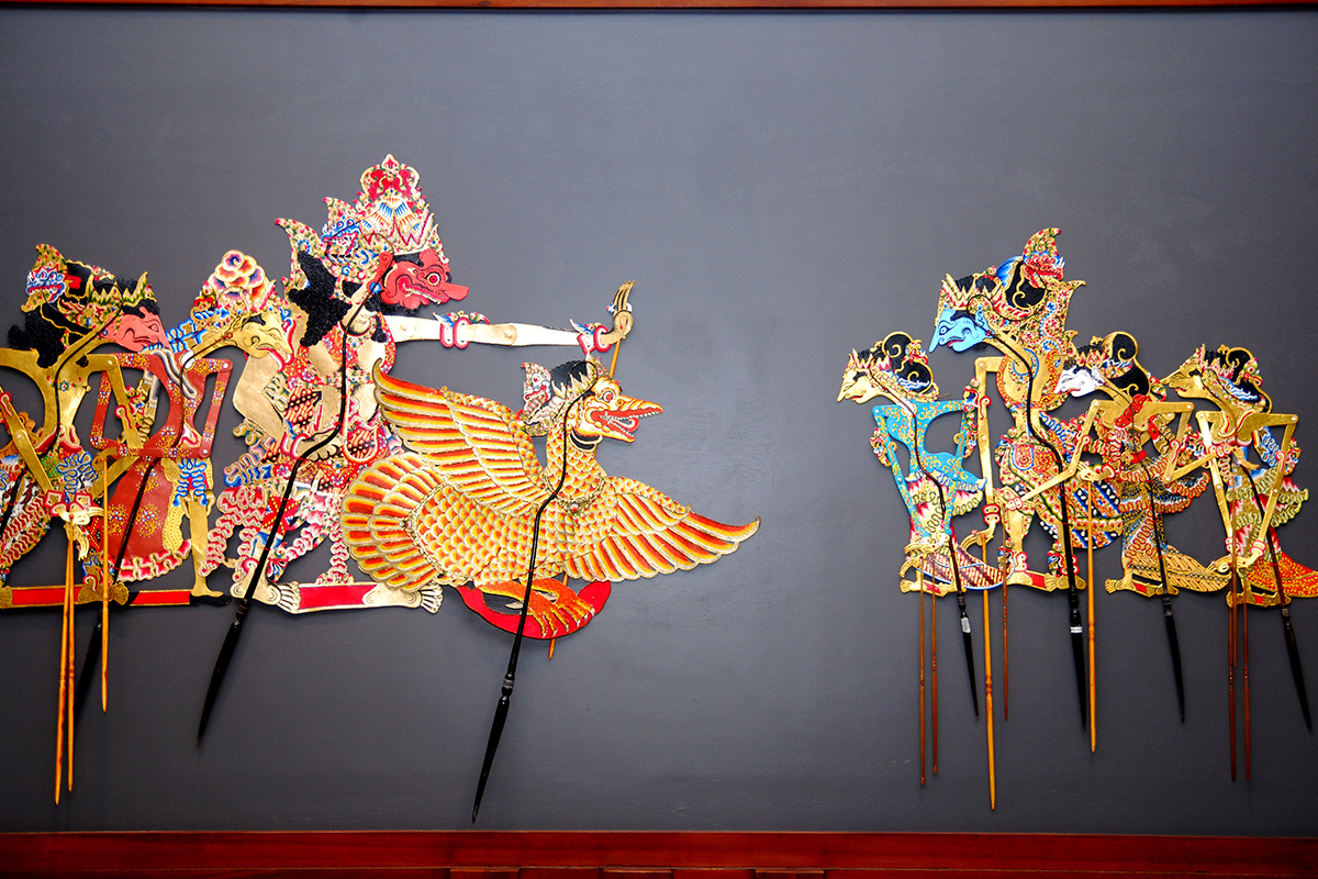  An image of a collection of intricately carved and painted Wayang Kulit puppets, a traditional form of shadow puppetry from Indonesia.