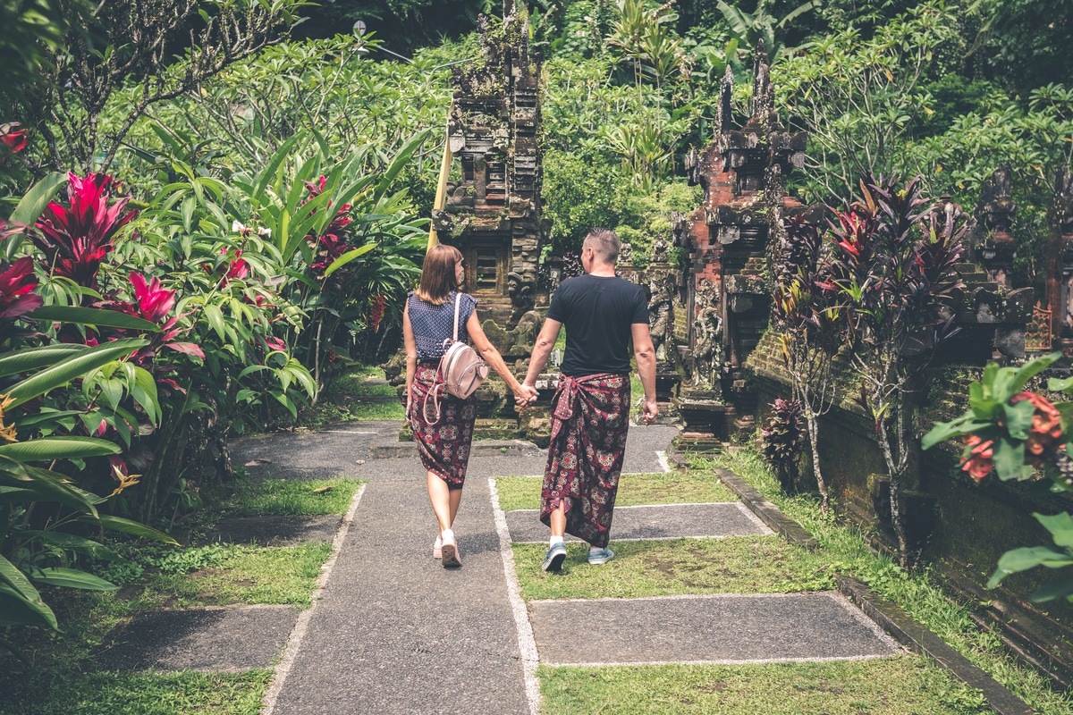 man and woman walking and holding hands