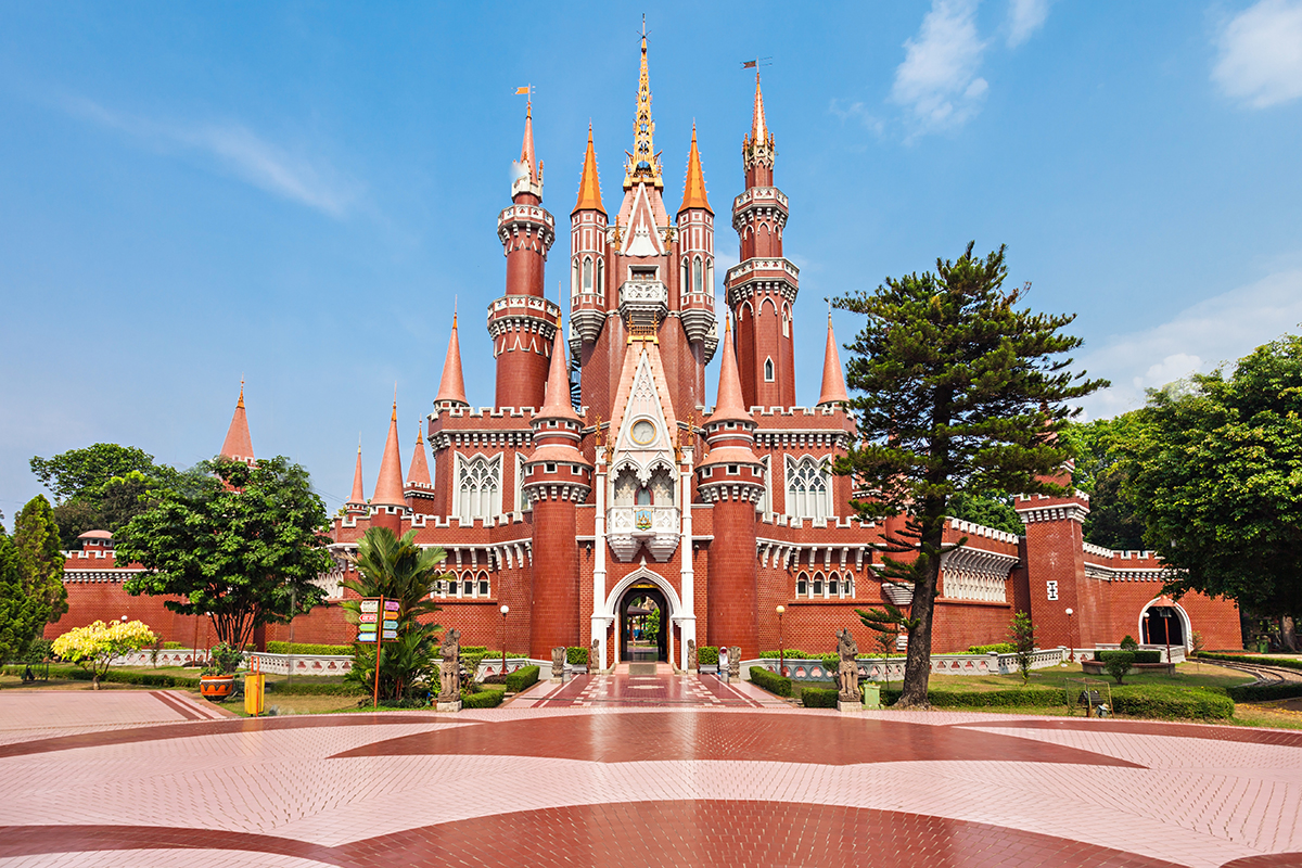 Taman Mini Indonesia Indah in Jakarta, a brick-colored castle, brick-colored floor, several green trees 