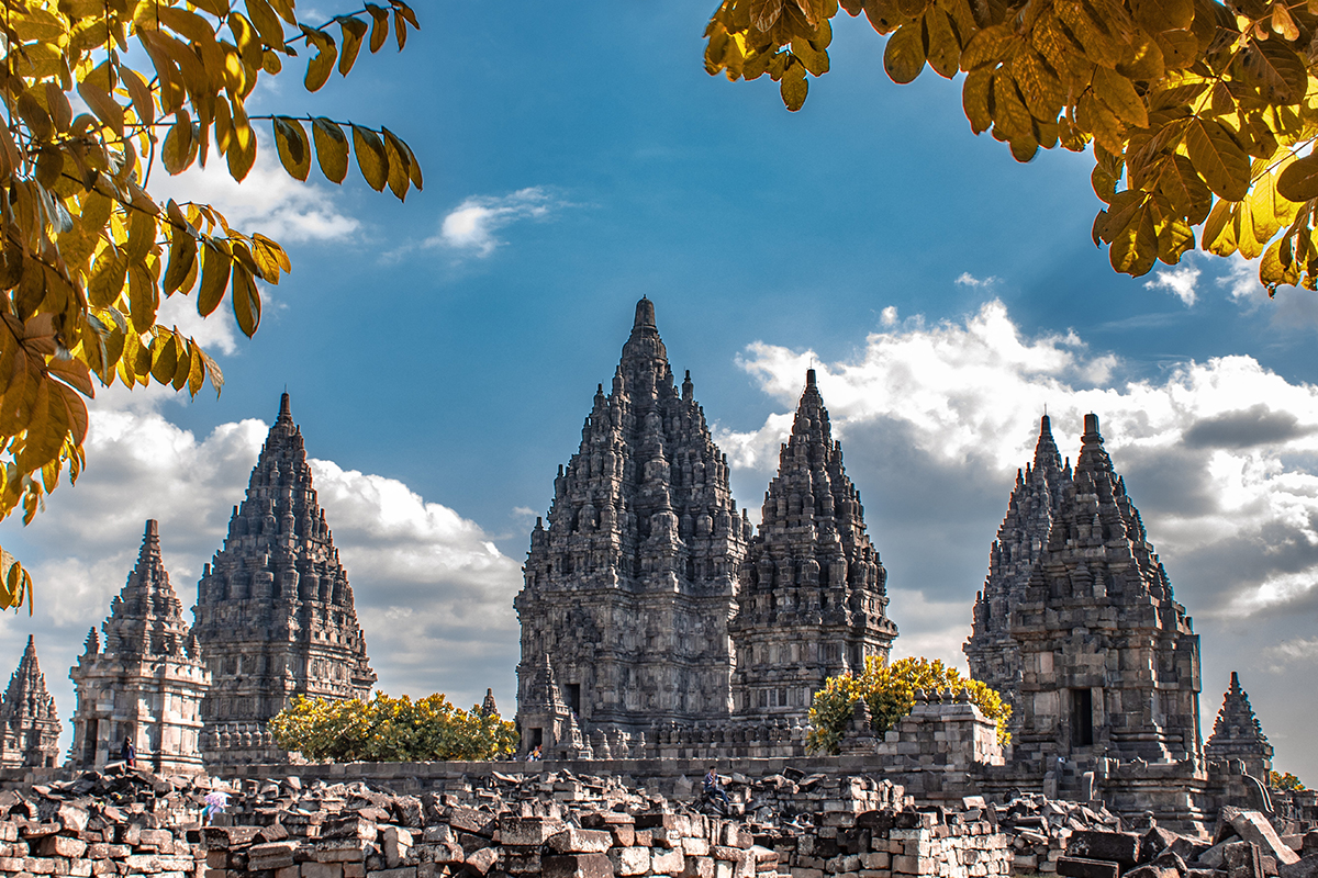 Prambanan Temple in Yogyakarta, ancient Hindu temple, blue sky, yellow leaves